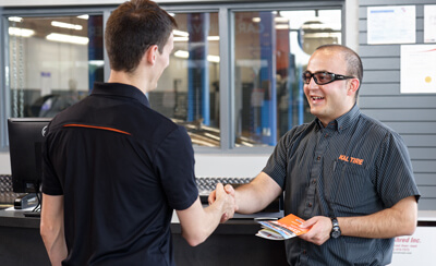 Kal Tire team member shaking customers hand