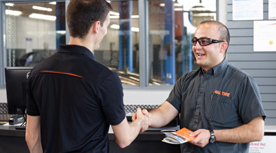 Kal Tire team member explaining Customer Care Plan