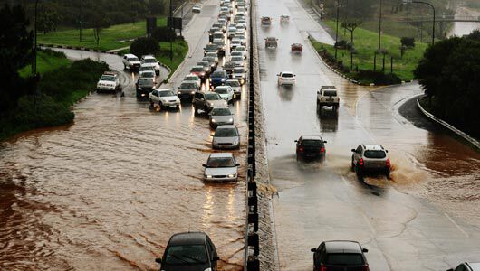 vehicles driving in mud and flooded road