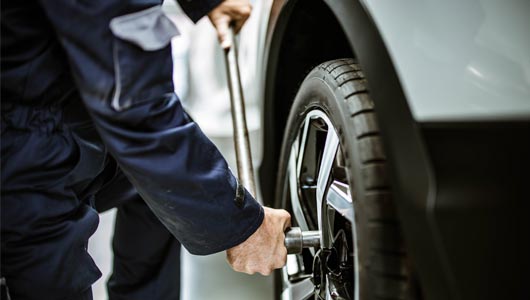 Kal Tire team member changing tire