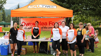 team members at a charity event standing under tent