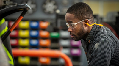 team member with safety glasses and ear protection