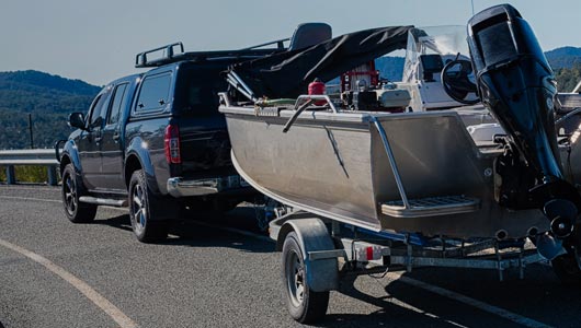 Vehicle pulling boat trailer