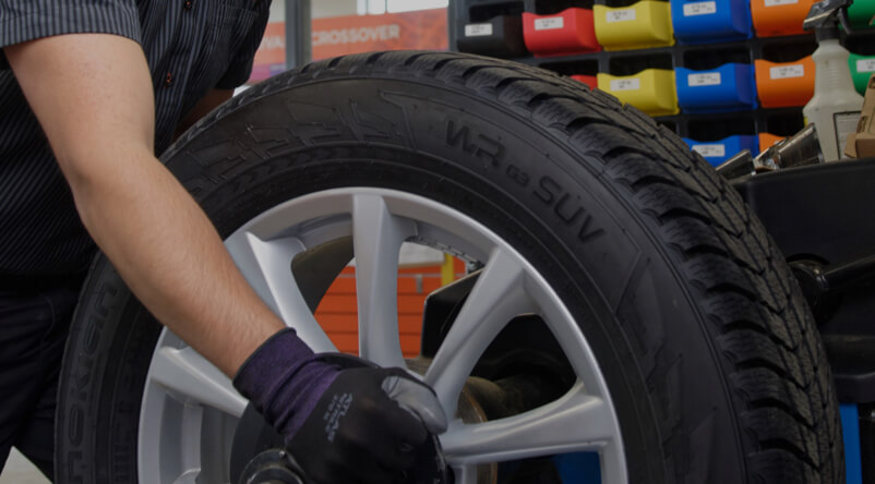 Kal Tire team member changing tire