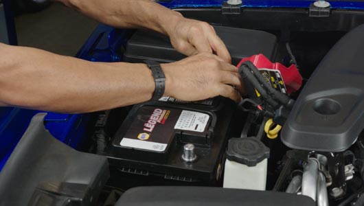 Kal Tire team member checking battery