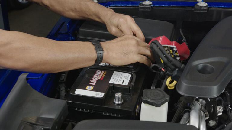 Kal Tire team member checking battery