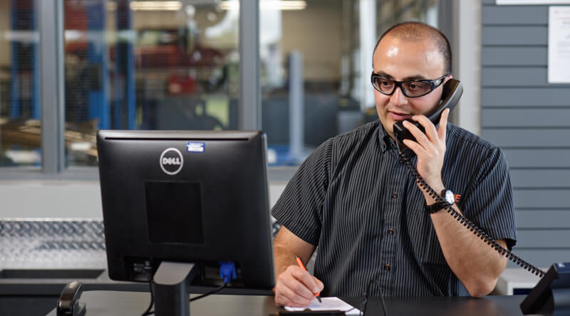 Kal Tire team member on phone