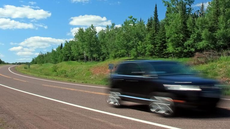 Car with winter tires on summer road